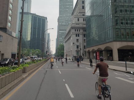 A cyclist riding through downtown Montreal